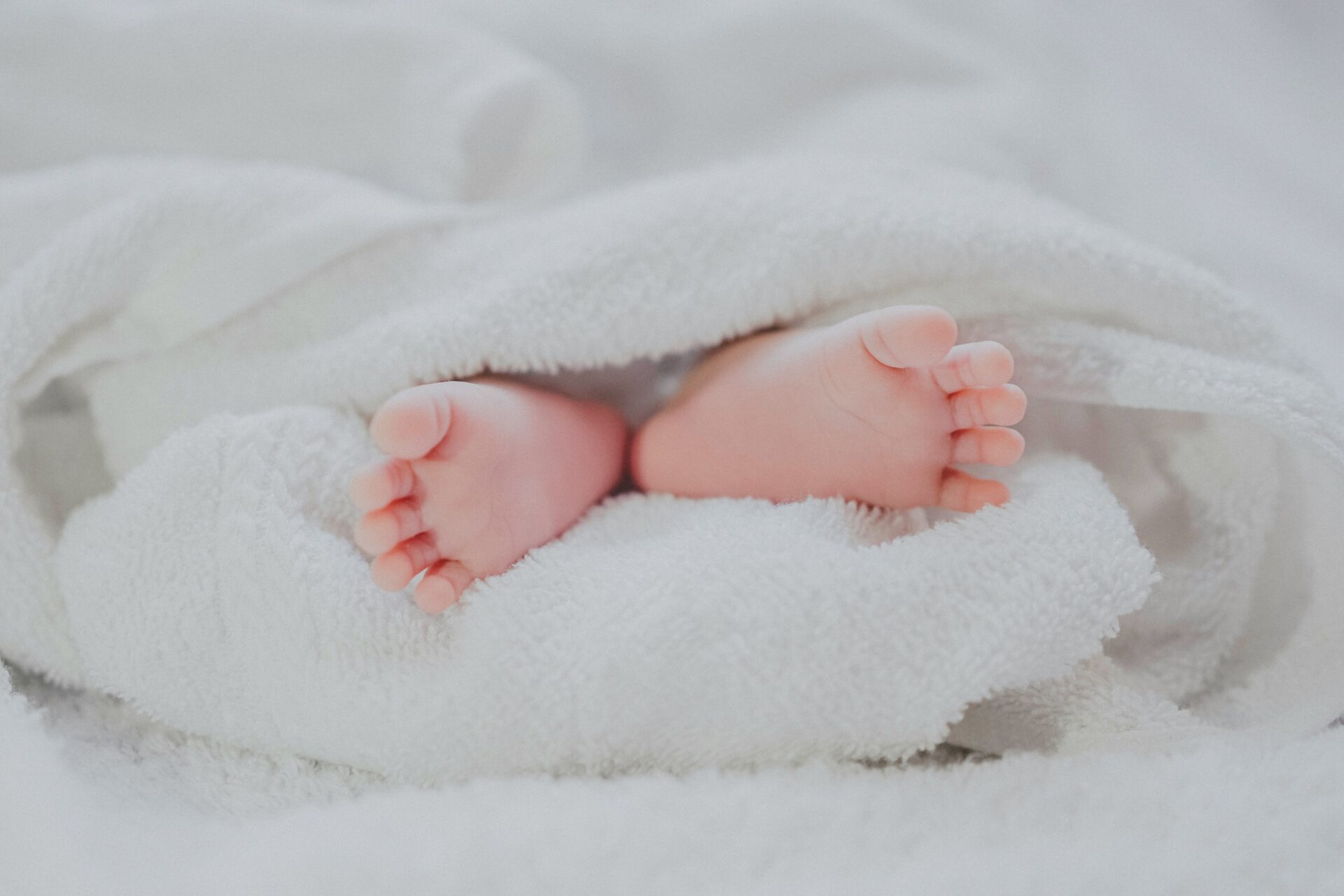 Baby's feet wrapped in a white blanket